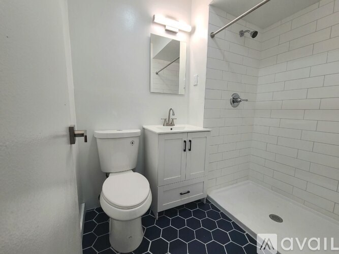 A white toilet sits next to a sink in a bathroom.