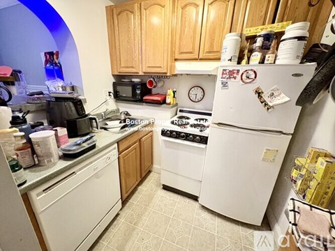 A kitchen with a white fridge and white stove.