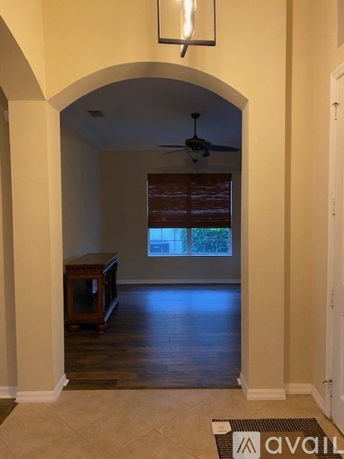 A room with a television and a fan.