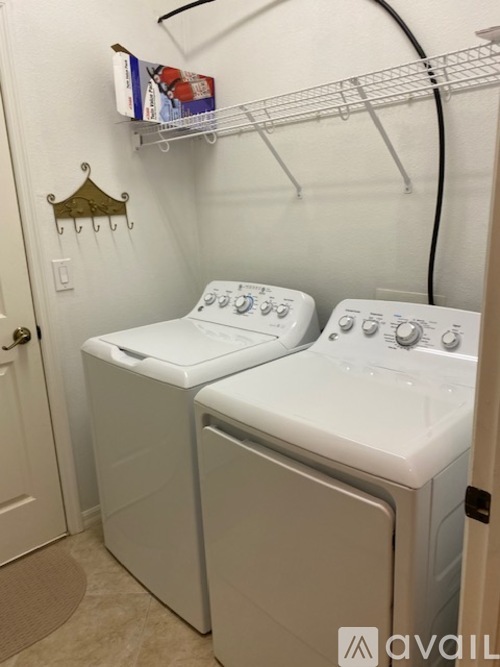 A small laundry room with a washer and dryer.