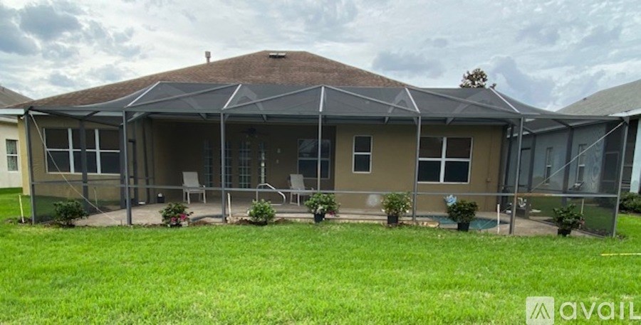 A house with a brown roof and a covered patio area.