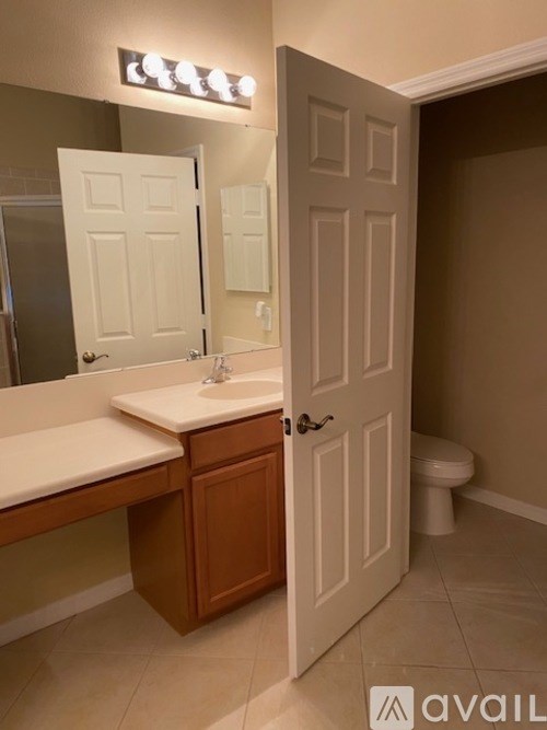 A bathroom with a white sink and a white toilet.