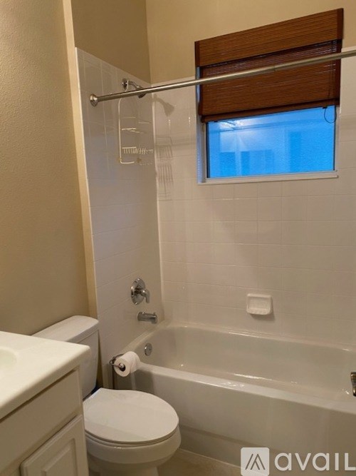 A bathroom with a toilet, sink, and bathtub.