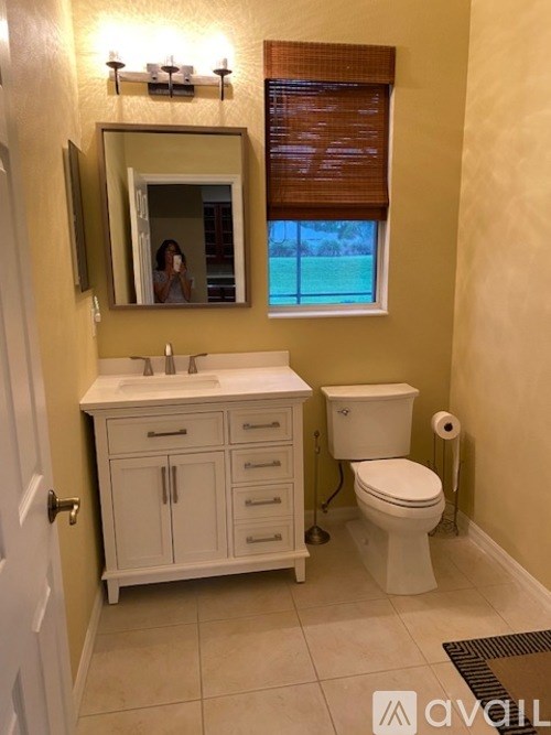A bathroom with a white toilet and sink.