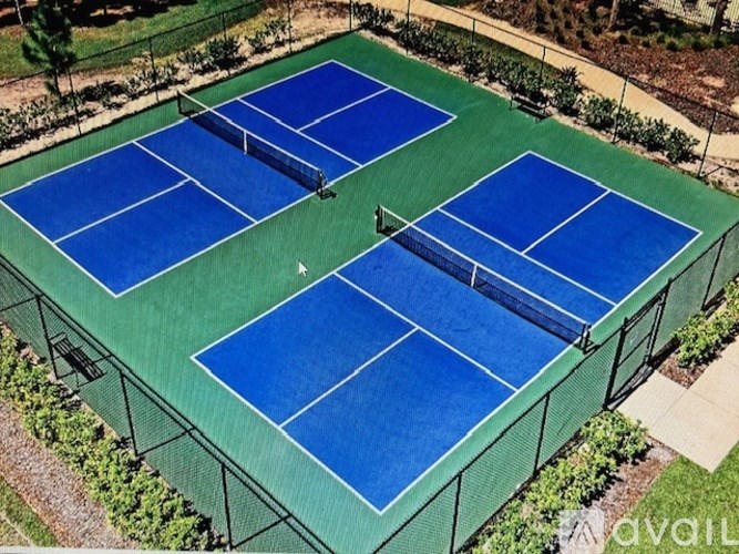 A tennis court with blue and green colors.