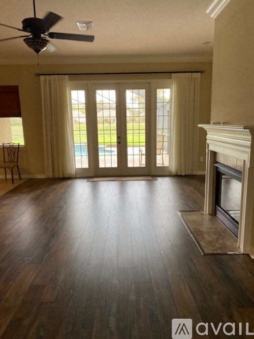 A living room with a fireplace and sliding glass doors.