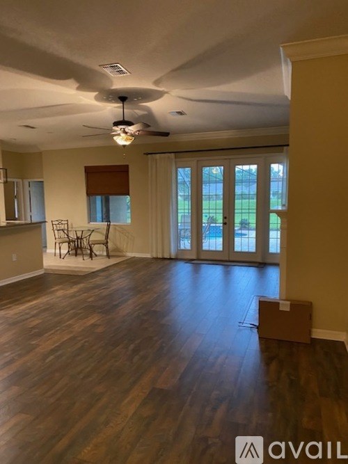 A room with wooden floors and a ceiling fan.