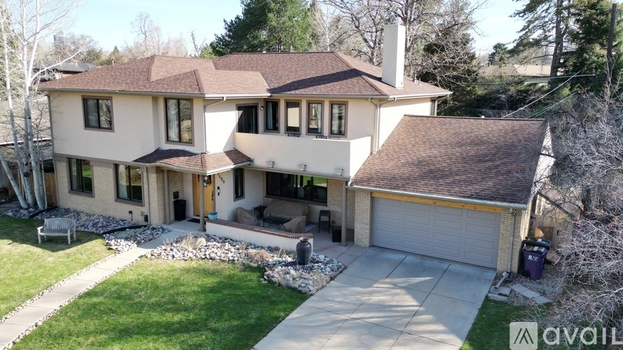 A house with a brown roof and a white garage door.