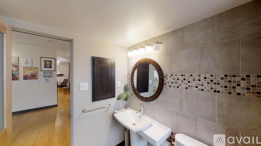 A bathroom with a white sink and a mirror above it.