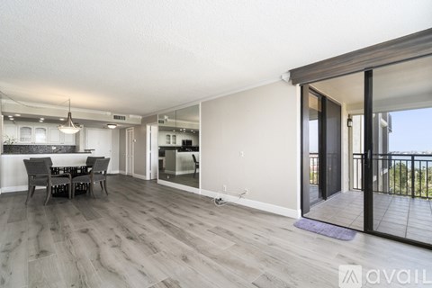 A spacious living room with a dining table and chairs.