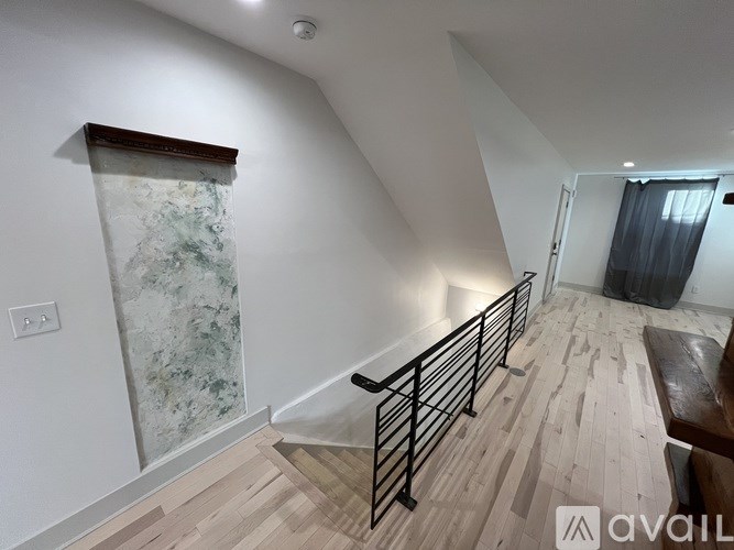 A room with a marble wallpapered wall and a wooden floor.
