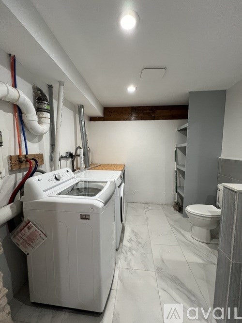 A small laundry room with a washer and dryer.