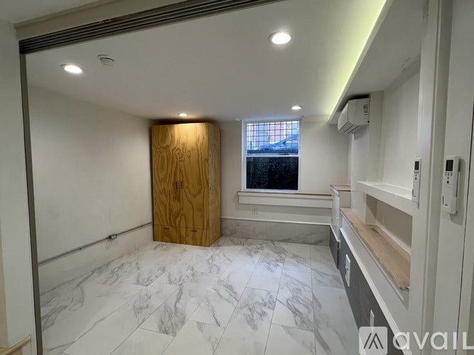 A room with a marble floor and a wooden door.