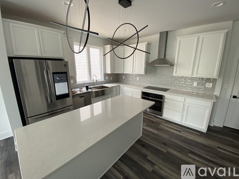 A modern kitchen with a large island in the center.