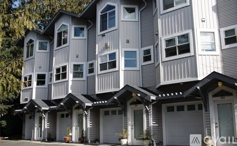 A row of modern houses with white and grey exterior.