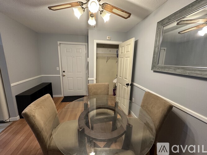 A dining room with a glass table and chairs.
