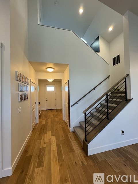 A hallway with a staircase and a skylight.