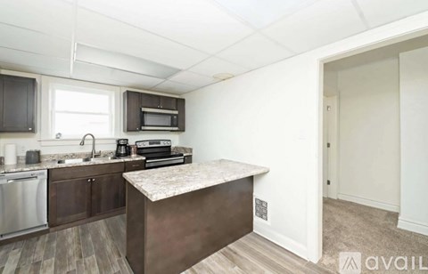 A kitchen with a stainless steel dishwasher and a microwave above the counter.