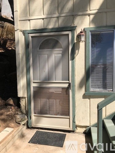 A white door with a glass window is open.