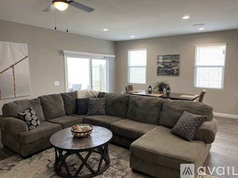 A living room with a large sectional sofa and a coffee table.