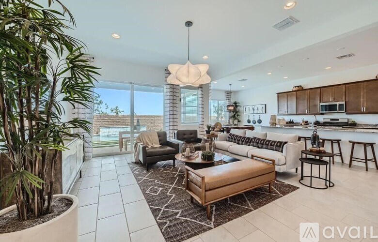 A modern living room with a large window, a sofa, and a coffee table.