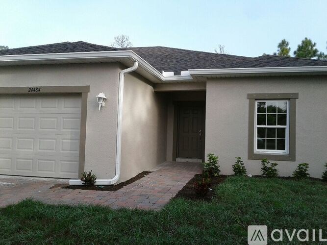 A house with a garage and a window is available for sale.