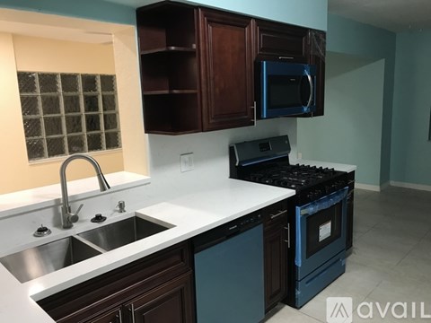 A kitchen with a stove top oven and a microwave.