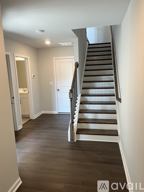 A staircase with a white railing and wooden steps.
