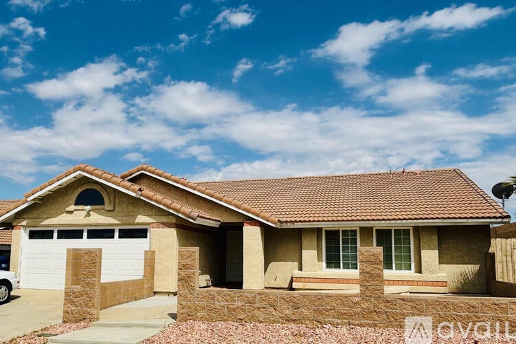 A house with a brown roof and a white garage door.