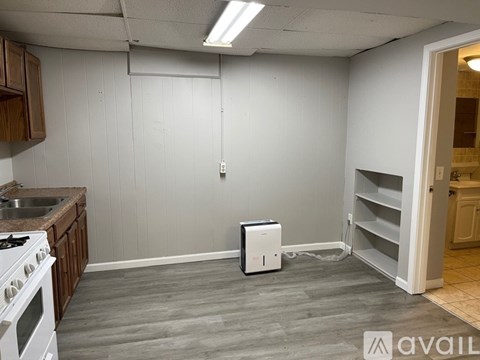 A kitchen with a white stove and a white fridge.