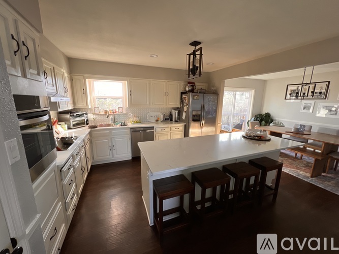 A modern kitchen with white cabinets and a large island.