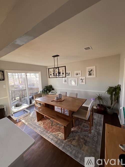 A dining room with a wooden table and chairs.