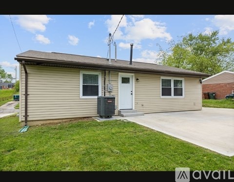 A small house with a white door and a window is for sale.
