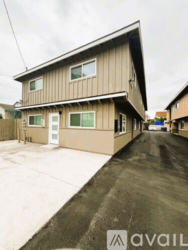 A two-story house with a garage is for sale.