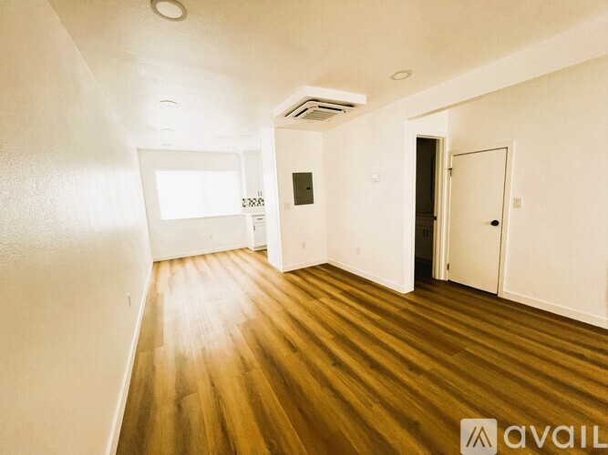 A room with wooden floors and white walls.