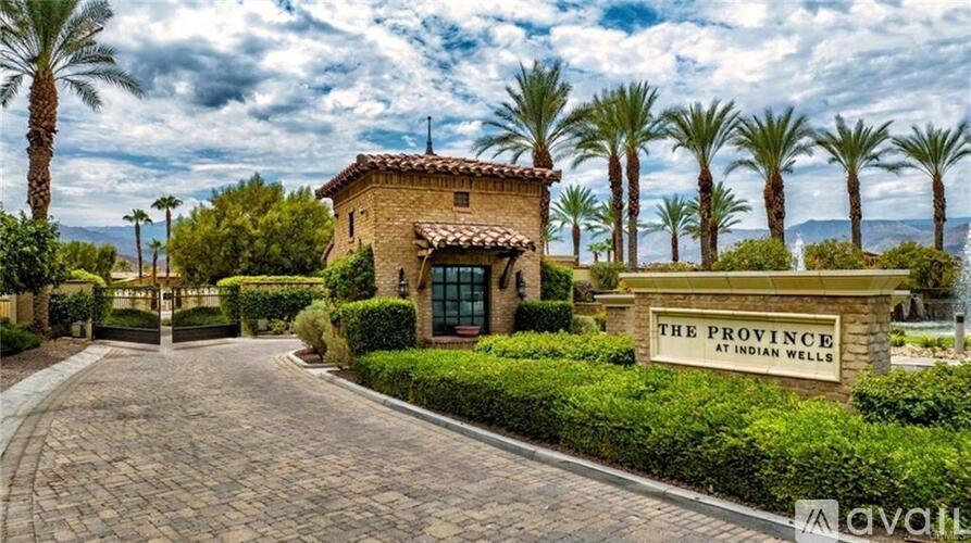A house with a sign that says "The Province at Indian Wells" in front of it.