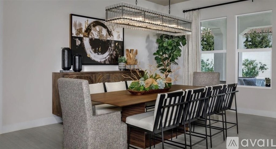 A modern dining room with a wooden table and chairs.