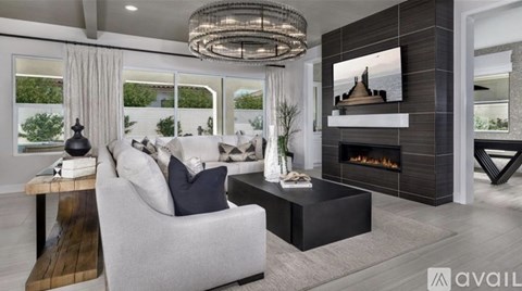 A modern living room with a fireplace and a large screen TV.