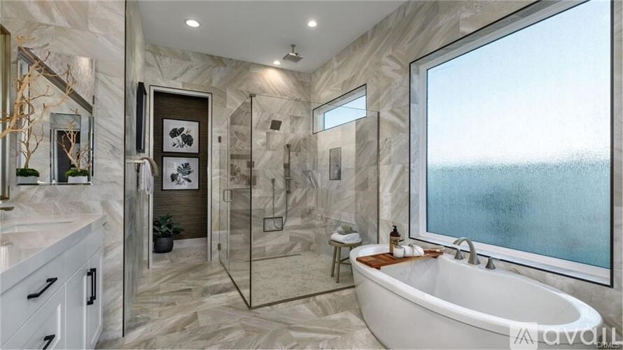 A bathroom with a large tub and a walk-in shower.