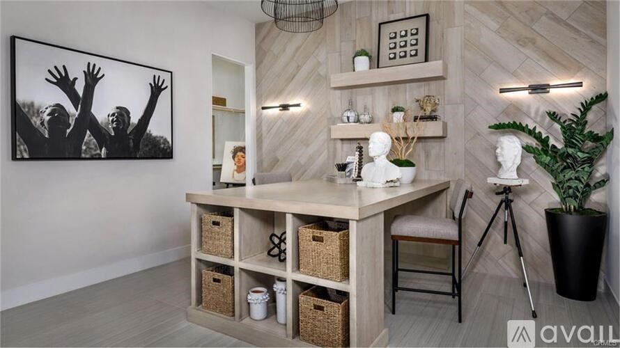 A room with a wooden floor and a large black and white photo on the wall.