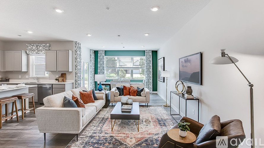 A living room with a grey couch and a brown armchair.