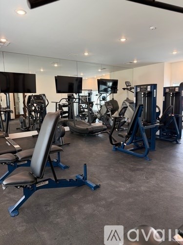 A gym with a variety of equipment including a leg press machine.