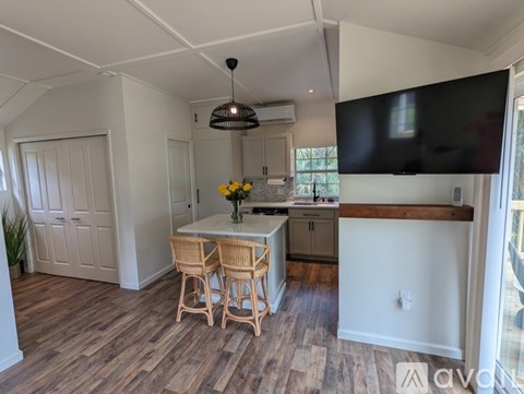 A kitchen with a table and chairs in the middle of the room.