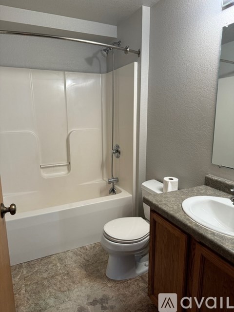 A bathroom with a toilet, sink, and bathtub.