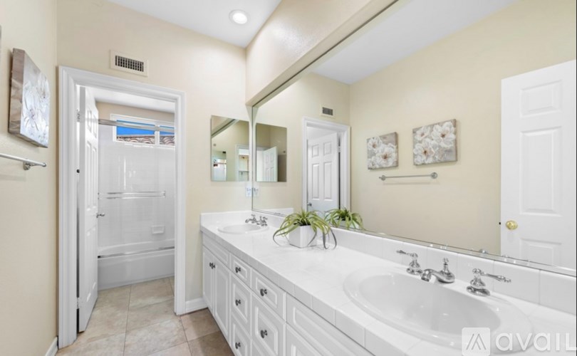 A bathroom with a white sink and a white bathtub.