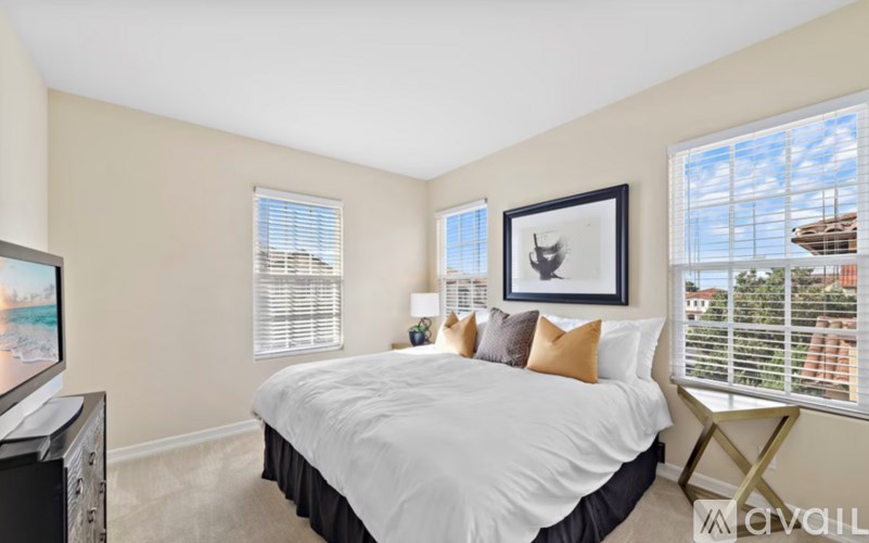 A bedroom with a large bed and a television.