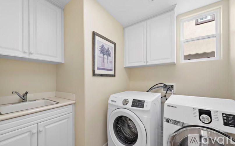 A small laundry room with a washer and dryer.
