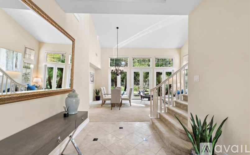 A spacious living room with a staircase leading to the upper floor.
