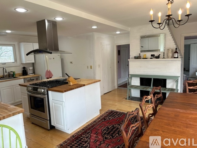 A modern kitchen with a wooden table and chairs.