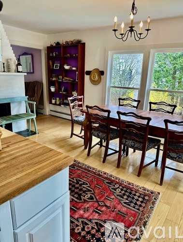 A dining room with a wooden table and chairs.